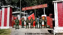 Members of the Myanmar National Democratic Alliance Army pose for a photograph in front of the seized army's infantry battalion in Kunlong township in Shan state, Myanmar, Sunday, Nov. 12, 2023. ((The Kokang online media via AP)