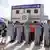 Coast guard officers salute during ceremonies for the inauguration of their new building