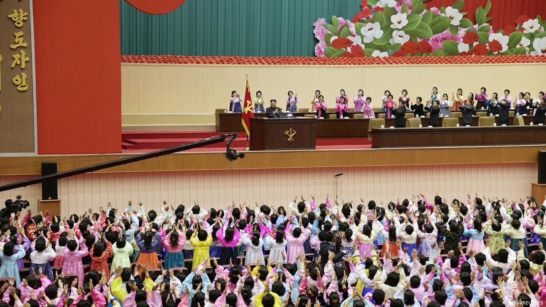 Women listen to North Korean leader Kim Jong Un during the National Mothers Meeting