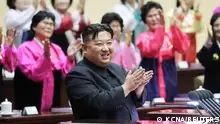 North Korea's leader Kim Jong Un applauds at the 5th National Meeting of Mothers in Pyongyang in this picture released by the Korean Central News Agency on December 4, 2023. KCNA via REUTERS ATTENTION EDITORS - THIS IMAGE WAS PROVIDED BY A THIRD PARTY. REUTERS IS UNABLE TO INDEPENDENTLY VERIFY THIS IMAGE. NO THIRD PARTY SALES. SOUTH KOREA OUT. NO COMMERCIAL OR EDITORIAL SALES IN SOUTH KOREA.