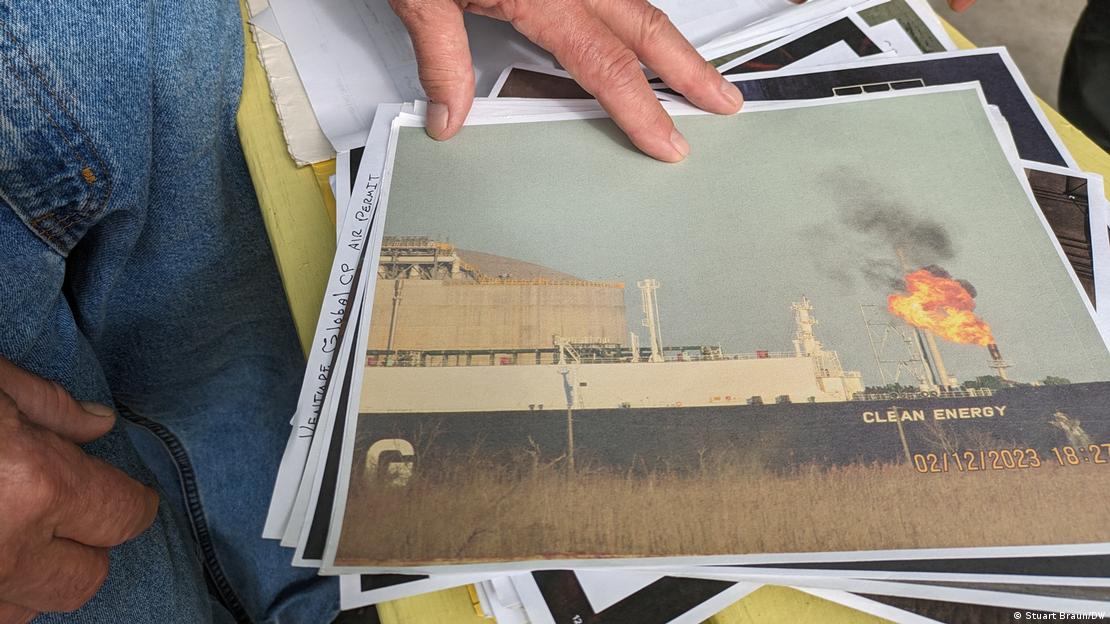 A man shows a picture of a gas flare