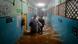 Two women wade through knee-high water in a corridor of Tambaram Government Hospital in Chennai Two women wade through knee-high water in a corridor of Tambaram Government Hospital in Chennai