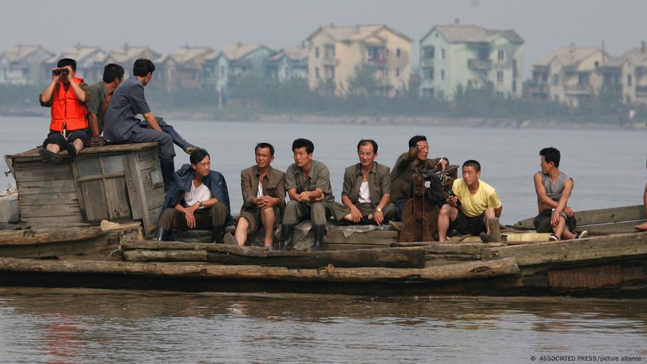 Severnokorejci na čamcu prelaze reku Jalu ka Kini