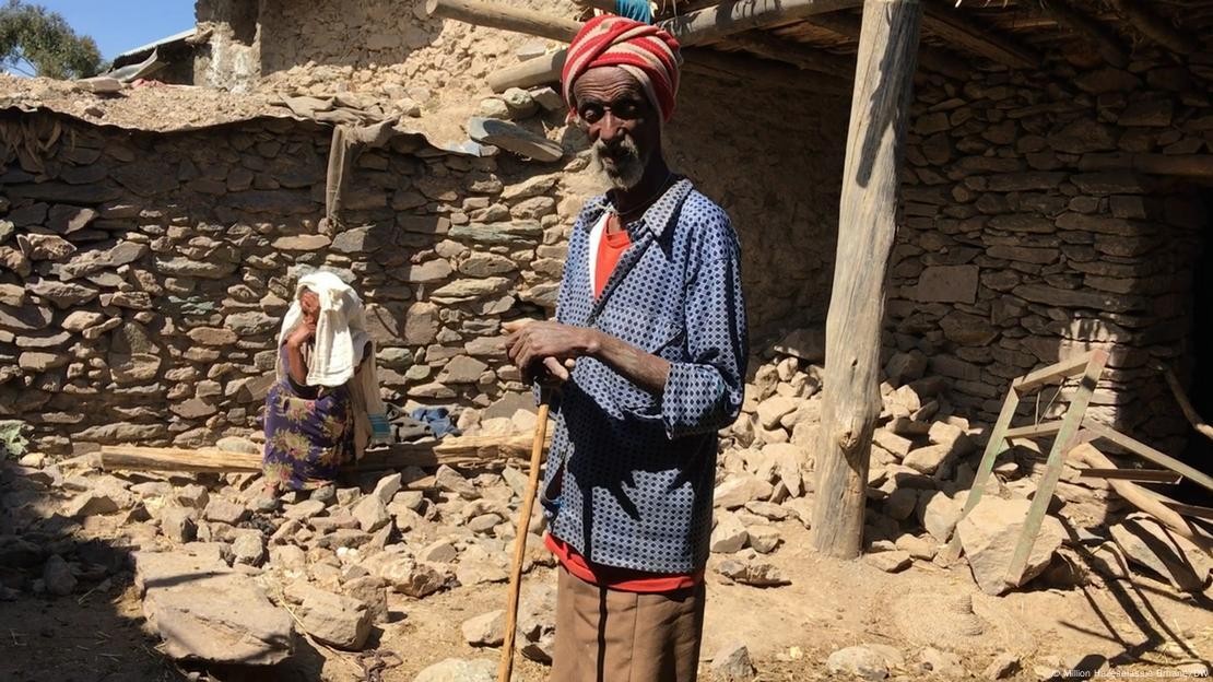 70-year-old Gebremariam Hagos stands in front of his empty family home in Atsibi village in Ethioipa's Tigray region. 