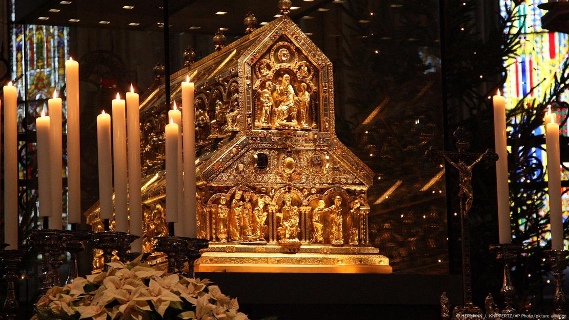 O santuário dourado dos Três Reis Magos, na Catedral de Colônia, com velas acesas na frente dele