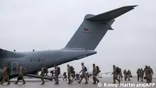 TOPSHOT - Returning troops of the German armed forces Bundeswehr who had served under the UN mission in Mali, MINUSMA, disembark of an A400M military cargo aircraft at the military air base in Wunstorf, northern Germany, on December 15, 2023. Germany on December 12, 2023 said it had ended its participation in the MINUSMA, in a pullout ordered by Mali's military leaders, after German troops had been a key pillar of the MINUSMA mission since Paris pulled its forces out from Mali in 2022. (Photo by Ronny HARTMANN / AFP)