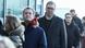 Serbian President Aleksandar Vucic waits in a queue to cast his vote