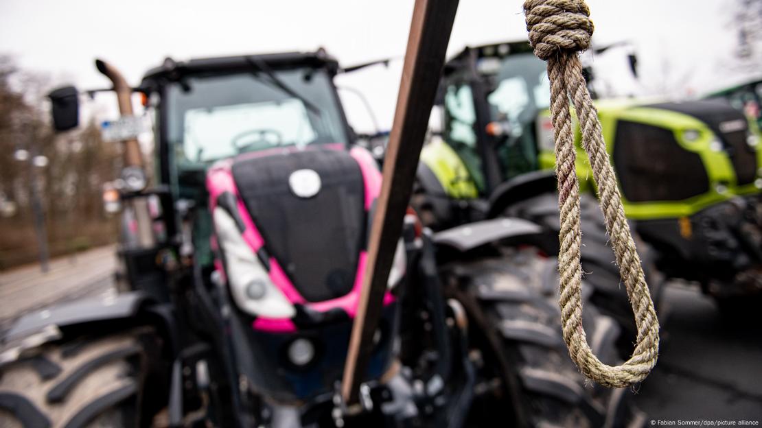 A tractor outfitted with a noose at a protest in Berlin