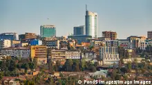 Long shot of Kigali downtown in Rwanda xkwx kigali, downtown, office, building, modern, skyline, hill, mountain, africa, rwanda, houses, skyscraper, facade, blue sky, hillside, african, crowd