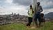 Boys in Rwanda stand next to a pole with the skyline of Kigali in the background Boys in Rwanda stand next to a pole with the skyline of Kigali in the background