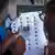 An official checks an election card at a polling station in Kinshasa