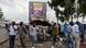 Internally displaced people walk past a billboard of President Felix Tshisekedi as they walk to vote at the Kanyaruchinya polling centre on December 20, 2023. Internally displaced people walk past a billboard of President Felix Tshisekedi as they walk to vote at the Kanyaruchinya polling centre on December 20, 2023.