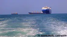 A picture taken during an organised tour by Yemen's Huthi rebels on November 22, 2023 shows the Galaxy Leader cargo ship (R), seized by Huthi fighters two days earlier, approaching the port in the Red Sea off Yemen's province of Hodeida. The Bahamas-flagged, British-owned Galaxy Leader, operated by a Japanese firm but having links to an Israeli businessman, was headed from Turkey to India when it was seized and re-routed to Hodeida November 19, according to maritime security company Ambrey. The Huthis said the capture was in retaliation for Israel's war against Hamas, sparked by the October 7 attack by the Palestinian militants who killed 1,200 people and took around 240 hostages, according to Israeli officials. (Photo by AFP)