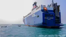 A picture taken during an organised tour by Yemen's Huthi rebels on November 22, 2023 shows the Galaxy Leader cargo ship, seized by Huthi fighters two days earlier, at a port on the Red Sea in Yemen's province of Hodeida. The Bahamas-flagged, British-owned Galaxy Leader, operated by a Japanese firm but having links to an Israeli businessman, was headed from Turkey to India when it was seized and re-routed to Hodeida November 19, according to maritime security company Ambrey. The Huthis said the capture was in retaliation for Israel's war against Hamas, sparked by the October 7 attack by the Palestinian militants who killed 1,200 people and took around 240 hostages, according to Israeli officials. (Photo by AFP)