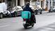 A deliver for Deliveroo on his bike or motorbike A deliver for Deliveroo on his bike or motorbike