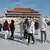Tourists visiting the Forbidden City at Dongzhi Festival in Beijing, China, December 22, 2023. All are in thick winter coats, walking carefully on snow