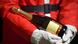 Stock photo: Close-up of the torso of a man wearing a Santa Claus costume cradling a bottle of champagne in his arms. Stock photo: Close-up of the torso of a man wearing a Santa Claus costume cradling a bottle of champagne in his arms.