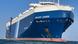 Photo taken from water level of a very large cargo ship in the sea. It is painted blue and the name 'Galaxy Leader' is written on the bow. Photo taken from water level of a very large cargo ship in the sea. It is painted blue and the name 'Galaxy Leader' is written on the bow.