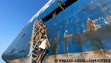 People walk down a ladder after they toured the Galaxy Leader commercial ship, seized by Yemen's Houthis last month, off the coast of al-Salif, Yemen December 5, 2023. REUTERS/Khaled Abdullah