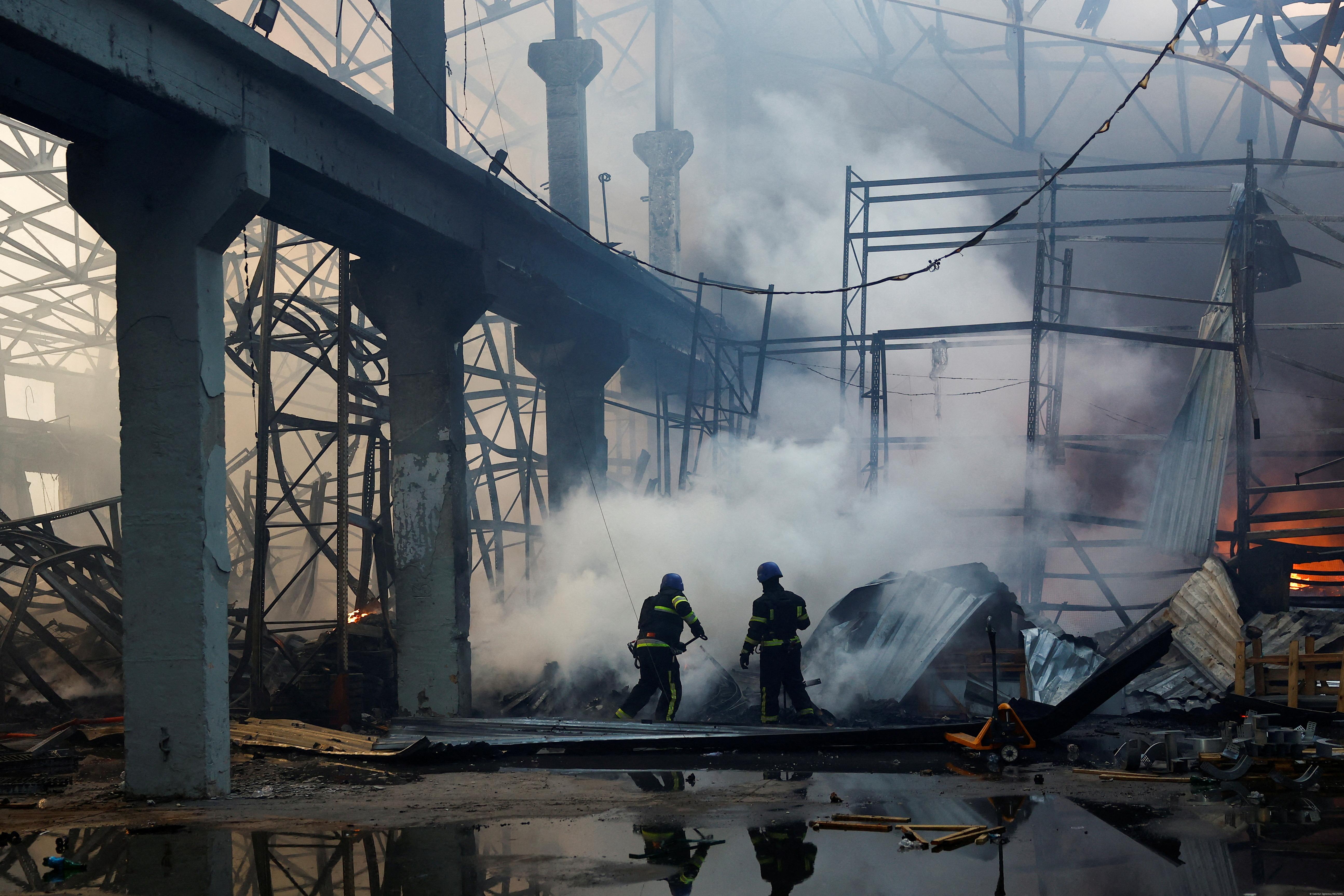  Firefighters work at a site of a warehouse heavily damaged during a Russian missile strike