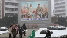 Pyongyang citizens pay respect to mosaics depicting smiling images of their late leaders Kim Il Sung and Kim Jong Il on the New Year day in Pyongyang, North Korea Monday, Jan. 1, 2024. (AP Photo/Jon Chol Jin)