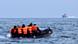 Migrants in an inflatable boat going across the English Channel. Migrants in an inflatable boat going across the English Channel.