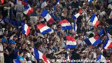 French fans wave flags during the Euro 2024 Group B qualifying soccer match between France and Ireland at Parc des Princes stadium in Paris, Thursday, Sept. 7, 2023. (AP Photo/Michel Euler)