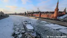 TOPSHOT - Ice covers the Moskva river as a cruise boat makes its way past the Kremlin on a frosty day in downtown Moscow on January 3, 2024, with the air temperature at around minus 24 degrees Celsius. (Photo by Vera Savina / AFP)