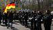 A demonstrator holds a German flag as he stands in front of a line of police officers during a protest rally against the German government's policy to battle the coronavirus pandemic A demonstrator holds a German flag as he stands in front of a line of police officers during a protest rally against the German government's policy to battle the coronavirus pandemic