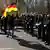  A demonstrator holds a German flag as he stands in front of a line of police officers during a protest rally against the German government's policy to battle the coronavirus pandemic