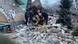 Rescue workers on a pile of cinderblocks at the site of a Russian missile strike Rescue workers on a pile of cinderblocks at the site of a Russian missile strike