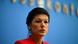 Sahra Wagenknecht with her lips pursed while speaking in front of a blue background at a press conference in Berlin Sahra Wagenknecht with her lips pursed while speaking in front of a blue background at a press conference in Berlin