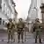 Soldiers stand guard outside the presidential palace in Quito, Ecuador, following a wave of violence around the nation