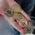 Foto de archivo de una persona que sostiene monedas con el logo de bitcoin