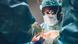 A surgeon operates on a patient assisted by other medics A surgeon operates on a patient assisted by other medics