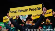 11/01/2024 *** People hold banners as supporters attend a campaign rally of the ruling Democratic Progressive Party (DPP) ahead of the presidential and parliamentary elections in Taipei, Taiwan January 11, 2024. REUTERS/Carlos Garcia Rawlins