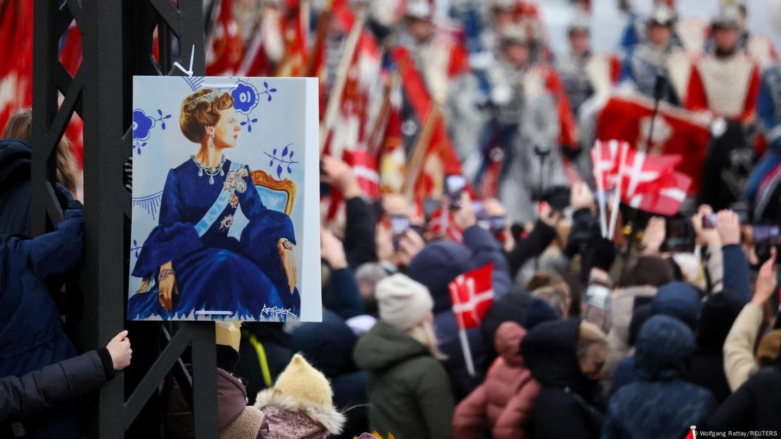 A placard depicting Danish Queen Margrethe is displayed as royal horse guards pass by on the day Queen Margrethe abdicates after 52 years on the throne, and her elder son, Crown Prince Frederik, ascends the throne as King Frederik X, in Copenhagen, Denmark, January 14, 2024. A placard depicting Danish Queen Margrethe is displayed as royal horse guards pass by on the day Queen Margrethe abdicates after 52 years on the throne, and her elder son, Crown Prince Frederik, ascends the throne as King Frederik X, in Copenhagen, Denmark, January 14, 2024.