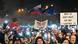 A large crowd of people holding up placards and EU and Slovak flags at a protest A large crowd of people holding up placards and EU and Slovak flags at a protest