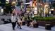 View of a street in Seoul with young women walking and chatting, and some sitting on outdoor seating View of a street in Seoul with young women walking and chatting, and some sitting on outdoor seating