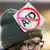 Anti-AfD protester with a sign on her hat on which the letters AfD are crossed out