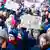 Учасники масової акції протесту проти правого екстремізму в німецькому Ганновері, 20 січня 2022 року, одна з яких тримає у руках плакат із написом: Фашизм - це не альтернатива! (німецькою мовою)