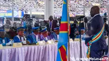 President Felix Tshisekedi listens to the speech of the judges of the Constitutional Court during his ceremony at the Stade des Martyrs in Kinshasa, on January 20, 2024. The president of the Democratic Republic of Congo, Felix Tshisekedi, was sworn in for a second five-year term on January 20, 2024, after sweeping elections that the opposition branded a sham while calling for protests. (Photo by Arsene Mpiana / AFP)