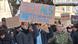 Two teenagers in the city of Koblenz hold a sign reading, in German: "Fascists in a party are still fascists"