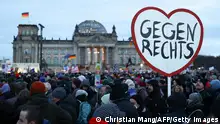 21/01/2024**TOPSHOT - A participant holds up a heart-shaped placard reading 'Against the right wing' during a demonstration against racism and far right politics in front of the Reichstag building in Berlin, Germany on January 21, 2024. Tens of thousands of people were expected to turn out again on January 21 to protest against the far-right AfD, after it emerged that party members discussed mass deportation plans at a meeting of extremists. (Photo by CHRISTIAN MANG / AFP) (Photo by CHRISTIAN MANG/AFP via Getty Images)