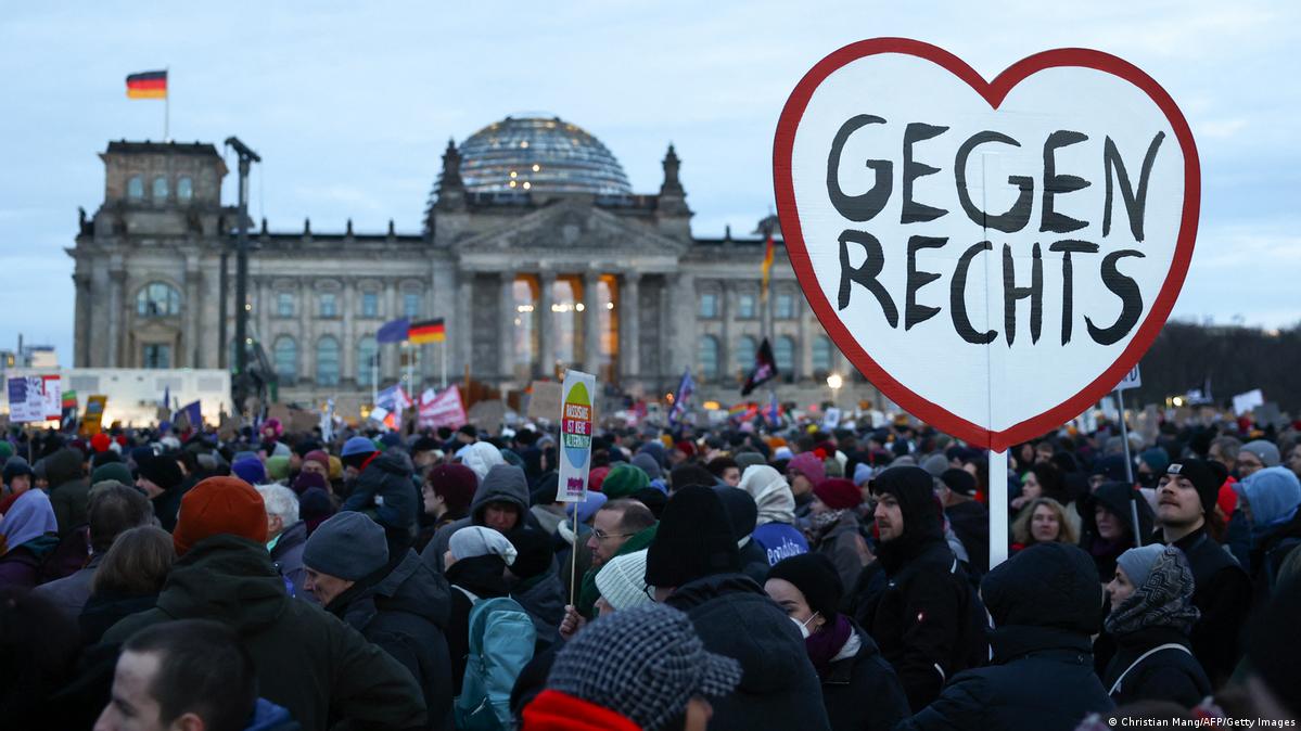 A participant holds up a heart-shaped placard reading 'Against the right wing' during a demonstration against racism and far right politics in front of the Reichstag building in Berlin, Germany on January 21, 2024