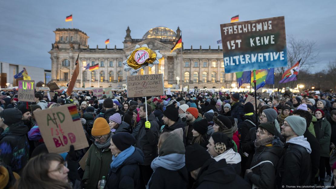 Protesters holding anti-AfD signs outside the Reichstag building in Berlin, January 21, 2024.