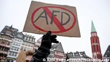 20/01/2024 *** A demonstrator holds a placard with a barred AfD sign refering to Germany's far-right Alternative for Germany (AfD) party during a demonstration against racism and far right politics in Frankfurt am Main, western Germany on January 20, 2024. Revelations that members of Germany's far-right AfD discussed mass deportation plans have pushed tens of thousands of people to protest and sparked a debate on whether the anti-immigrant party should be banned. From Cologne to Leipzig to Nuremberg, Germans across the country have poured into the streets over the last week, with another 100 demonstrations expected through the weekend. (Photo by Kirill KUDRYAVTSEV / AFP) (Photo by KIRILL KUDRYAVTSEV/AFP via Getty Images)