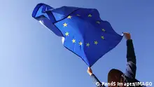 08/07/2023 *** Woman holding European Union flag against blue sky outdoors, low angle view Model Released Property Released xkwx angle back background blue brussels campaign clear cloth color community concept cooperation country culture decision democracy economy election eu euro europe european fabric female flag fluttering government holding international low national official outdoors parliament patriotism person politics sign sky stars sunny symbol textile travel union united view voting wind woman