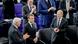 German President Frank-Walter Steinmeier (left) and Chancellor Olaf Scholz (right) applauded French President Emmanuel Macron after he delivered the eulogy in the German parliament in Berlin German President Frank-Walter Steinmeier (left) and Chancellor Olaf Scholz (right) applauded French President Emmanuel Macron after he delivered the eulogy in the German parliament in Berlin
