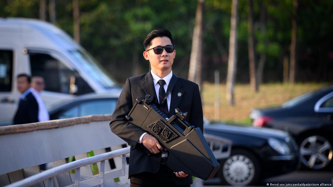 Man holding an electronic weapon to combat drones